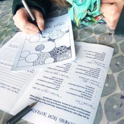 Person filling circular shapes with patterns on a 'Circle Zen' worksheet surrounded by drawing instructions.